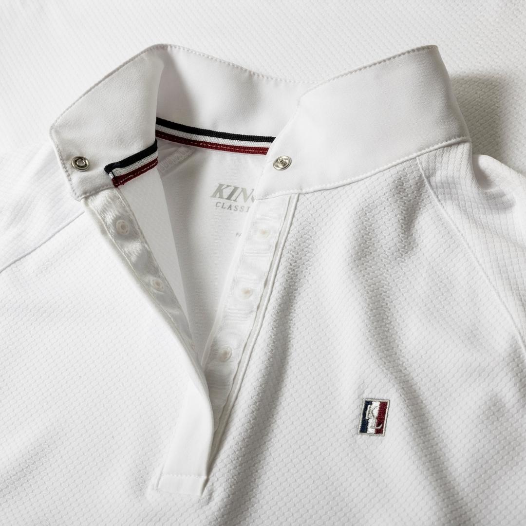 White polo shirt with a three-button placket, textured fabric, and a small left-chest brand logo patch.