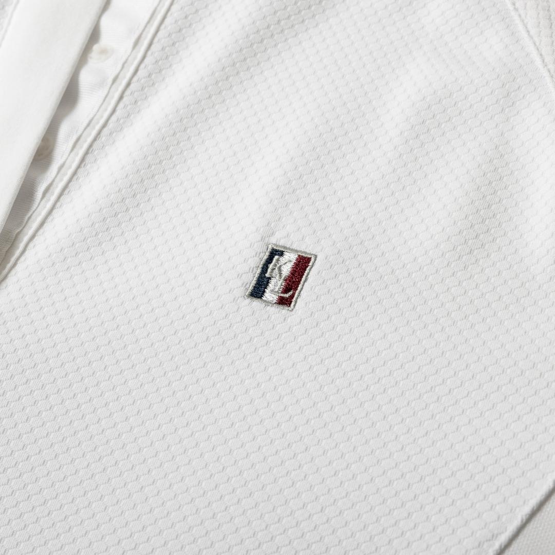 White textured polo shirt with a small embroidered MLB logo on the chest.