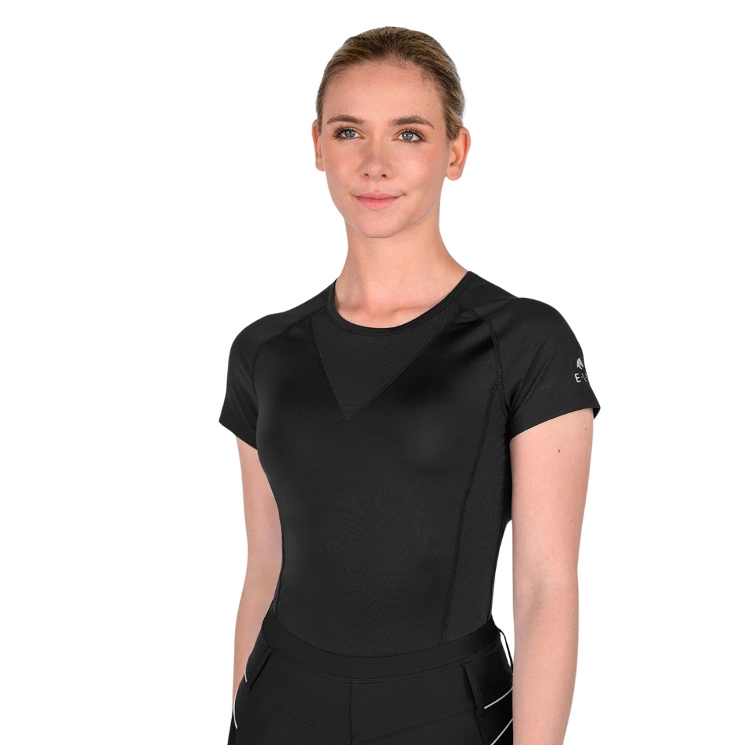 Woman wearing a black short-sleeve athletic top, posing for a studio portrait.