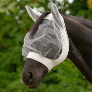 Horse wearing a white mesh fly mask outdoors with a green, blurred background.