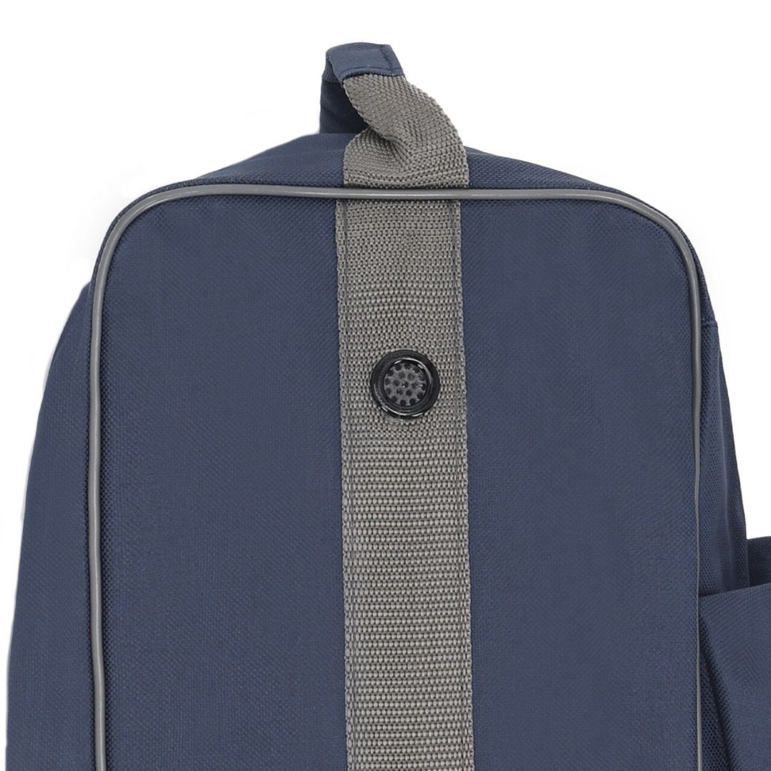 Close-up of a navy backpack front: gray center strap with a circular black button.