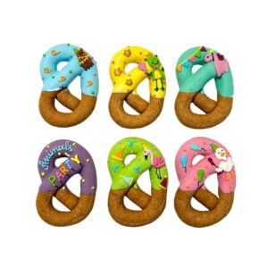 Six colorful frosted donuts shaped like the number 0, arranged in two rows of three, each with bright icing and fun decorations for a party look